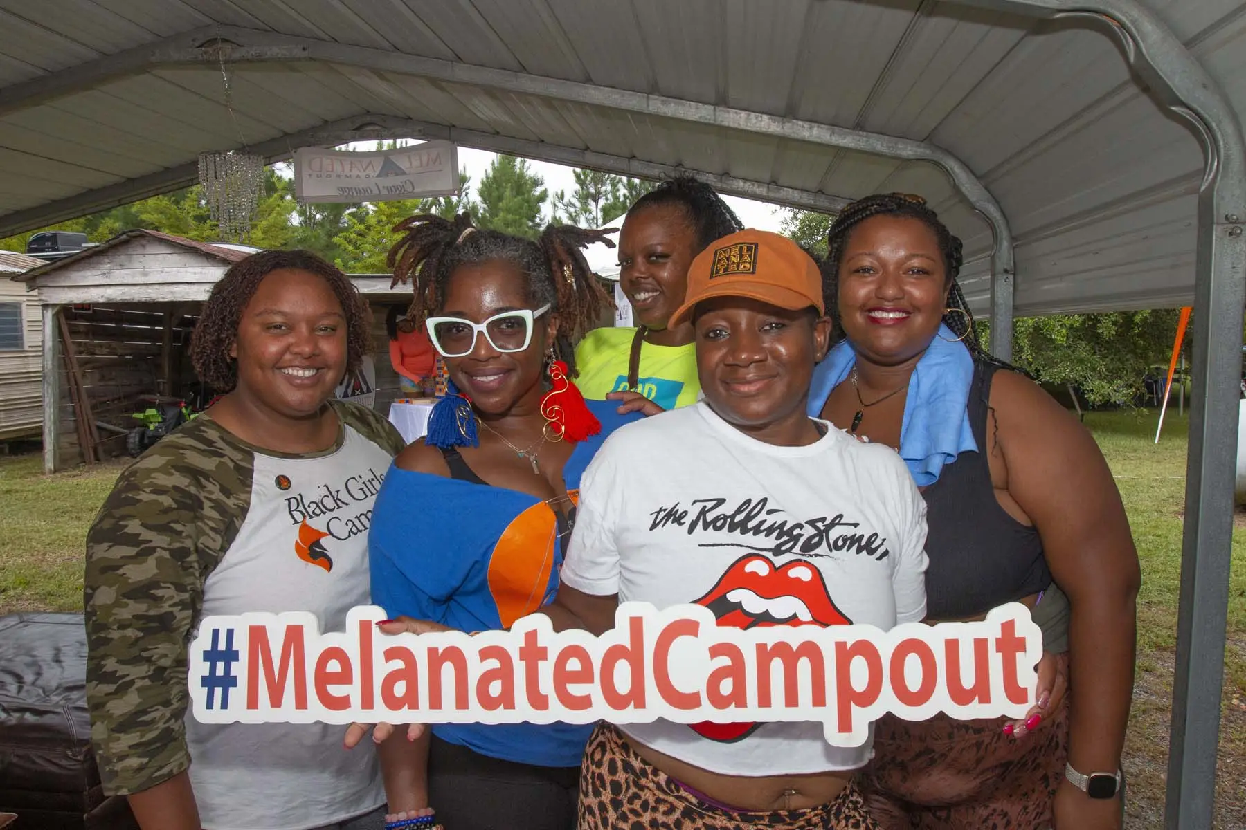 Friends laughing and connecting at Melanated Campout camping weekend in Georgia