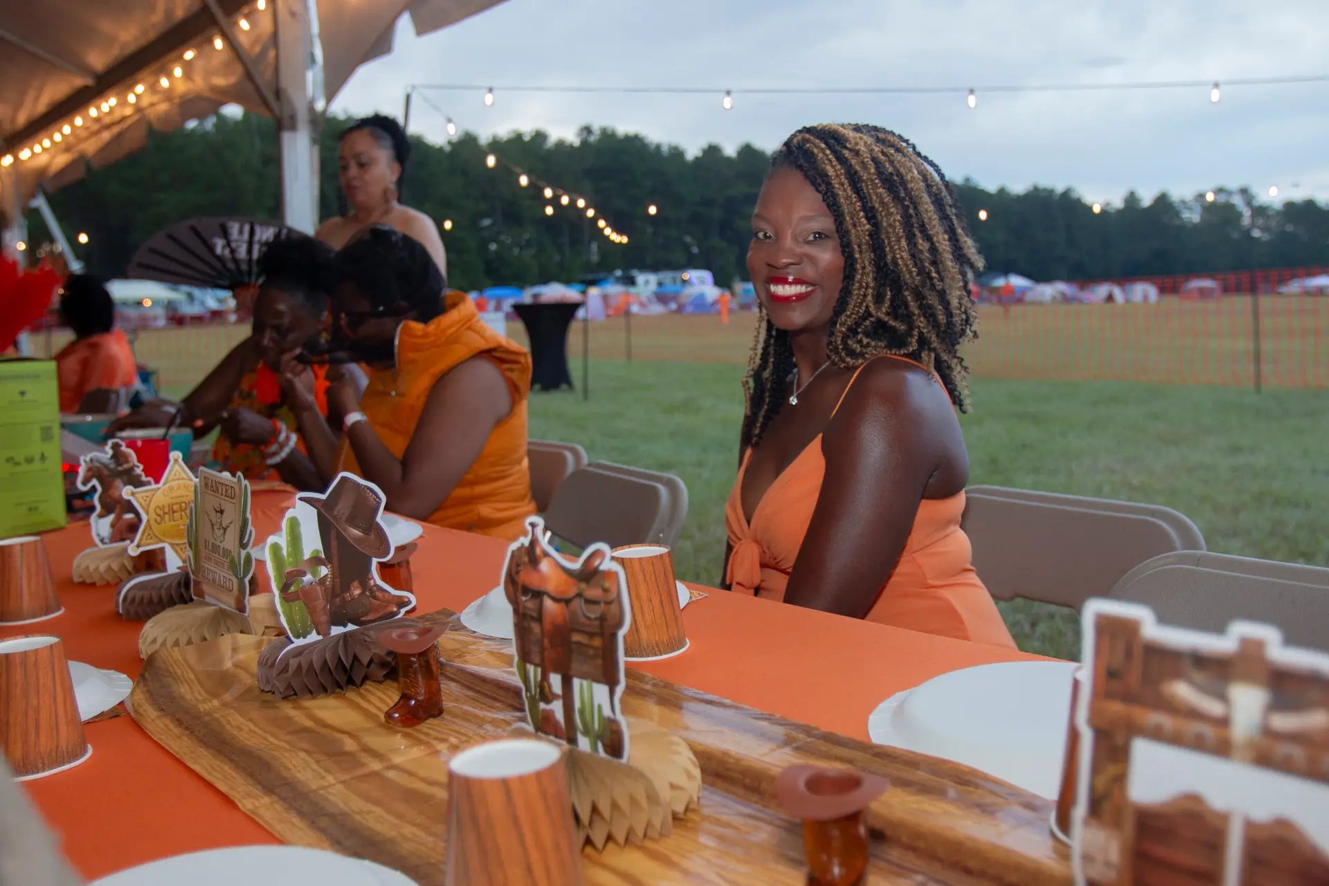 Dinner in Orange at Melanated Campout — napkin wave moment