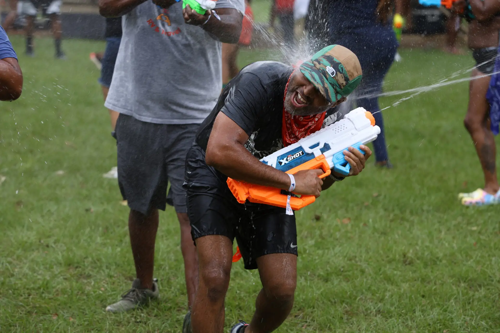 Watergun battle at Melanated Campout — adults having a blast outdoors in Cordele Georgia