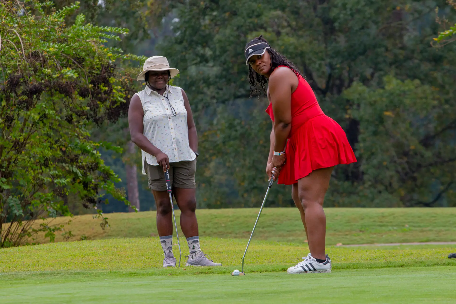 Cousin's Cup Golf Tournament @ Melanated Campout 2 Three Camp Cousins lining up a putt together on the green at Lake Blackshear